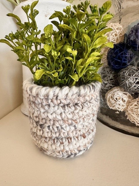 Faux plants with crochet pot covers